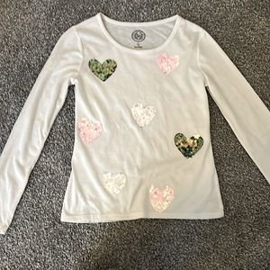White long sleeve with different colored hearts.
